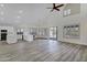 Bright living room featuring vaulted ceilings, wood floors, and modern white trim at 11257 E Reginald Ave, Mesa, AZ 85212