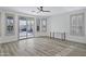 Spacious living room with wood-look floors, lots of natural light, and a view of the pool at 11257 E Reginald Ave, Mesa, AZ 85212