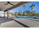 This covered patio looks out to the pool, mature trees, and landscaping at 11257 E Reginald Ave, Mesa, AZ 85212