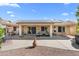 Large backyard patio with ceiling fans, lounge chairs, and desert landscaping at 14981 W Robson N Cir, Goodyear, AZ 85395
