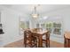 Bright dining area with a wooden table set near a window with white shutters at 14981 W Robson N Cir, Goodyear, AZ 85395