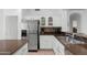 Kitchen showcasing stainless steel refrigerator, white cabinets, updated backsplash, and sink with countertop space at 14981 W Robson N Cir, Goodyear, AZ 85395