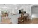 Open-concept kitchen with breakfast bar seating, stainless steel appliances, and adjacent dining area at 14981 W Robson N Cir, Goodyear, AZ 85395