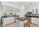 Kitchen showcasing stainless steel appliances, white cabinets and eat-in kitchen island with dark countertops at 14981 W Robson N Cir, Goodyear, AZ 85395