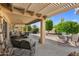 Relaxing covered patio area with comfortable seating and well-maintained landscaping at 14981 W Robson N Cir, Goodyear, AZ 85395