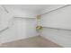 Walk-in closet featuring carpet floor, single shelf, and hanging rods at 14981 W Robson N Cir, Goodyear, AZ 85395