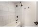 Modern bathroom featuring a white tub and shower combo with subway tile and matte black hardware and accents at 1621 N Chippewa Dr, Chandler, AZ 85224
