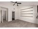 Spacious bedroom with a ceiling fan, large window, and a walk-in closet for ample storage at 1621 N Chippewa Dr, Chandler, AZ 85224