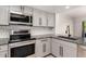 Updated kitchen featuring gray cabinets, stainless steel appliances, granite countertops, and subway tile backsplash at 1621 N Chippewa Dr, Chandler, AZ 85224
