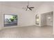 Bright living room showcasing tile floors, a modern ceiling fan, and arched windows offering backyard views at 1621 N Chippewa Dr, Chandler, AZ 85224