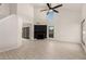 Bright living room boasting vaulted ceilings, wood-look tile flooring, and a black shiplap fireplace at 1621 N Chippewa Dr, Chandler, AZ 85224