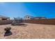 View of the backyard with a fire pit, trampoline, and the property's privacy wall at 1744 W Hopi Dr, Coolidge, AZ 85128