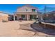 Large backyard with covered patio, space for entertaining, and a trampoline under a clear blue sky at 1744 W Hopi Dr, Coolidge, AZ 85128