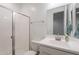 Clean, bright bathroom with white vanity, framed mirror, and walk-in shower with glass door at 1744 W Hopi Dr, Coolidge, AZ 85128