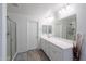Clean, modern bathroom with white cabinets, a large mirror, a glass-enclosed shower, and tile floors at 1744 W Hopi Dr, Coolidge, AZ 85128