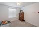 Clean bedroom features a window, ceiling fan, and dresser; perfect for comfortable living at 1744 W Hopi Dr, Coolidge, AZ 85128