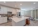 Open kitchen with an island, stainless steel appliances, and modern white cabinetry at 1744 W Hopi Dr, Coolidge, AZ 85128