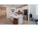 Open kitchen with an island, stainless steel appliances, and modern white cabinetry at 1744 W Hopi Dr, Coolidge, AZ 85128