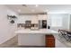 Open kitchen with an island, stainless steel appliances, and modern white cabinetry at 1744 W Hopi Dr, Coolidge, AZ 85128