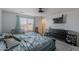 Bright main bedroom with a large bed, a view outside the window, dark dresser and a TV at 1744 W Hopi Dr, Coolidge, AZ 85128