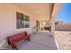 Covered patio with a bench, outdoor grill, and ample space for entertaining and relaxing at 1744 W Hopi Dr, Coolidge, AZ 85128