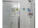 Clean shower with a sliding glass door and built-in shelving for toiletries at 1744 W Hopi Dr, Coolidge, AZ 85128