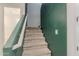 Carpeted staircase with a green accent wall and white trim leading to the upper level of the home at 1744 W Hopi Dr, Coolidge, AZ 85128