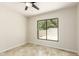 Light and airy bedroom with ceiling fan and window overlooking the private patio at 1831 N 77Th St, Scottsdale, AZ 85257