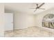 Bedroom featuring tile floors, ceiling fan, window, and white trim at 1831 N 77Th St, Scottsdale, AZ 85257