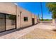 View of backyard featuring patio, rock bed, desert landscaping, and stucco exterior at 1831 N 77Th St, Scottsdale, AZ 85257