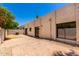 Beautiful back exterior featuring a private patio, desert landscaping, and stucco wall at 1831 N 77Th St, Scottsdale, AZ 85257