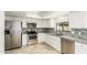 Bright kitchen with stainless steel appliances, white cabinets, and a stylish backsplash at 1831 N 77Th St, Scottsdale, AZ 85257
