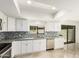 Well-lit kitchen featuring white cabinetry, stainless steel appliances, and an attractive backsplash at 1831 N 77Th St, Scottsdale, AZ 85257
