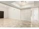 Open living room with a tray ceiling, modern paint, and tile floors at 1831 N 77Th St, Scottsdale, AZ 85257