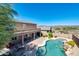 Aerial view of the home, backyard, patio, pool and spa, and desert landscape in the distance at 18375 E San Ignacio Ct, Gold Canyon, AZ 85118