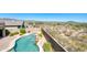 Aerial view of backyard, pool, spa, and patio, set against the backdrop of the surrounding desert landscape at 18375 E San Ignacio Ct, Gold Canyon, AZ 85118