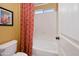 This bathroom features a toilet, tub and decorative shower curtain at 18375 E San Ignacio Ct, Gold Canyon, AZ 85118
