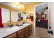 Bathroom featuring double sinks, a large mirror, and access to an adjacent bedroom at 18375 E San Ignacio Ct, Gold Canyon, AZ 85118