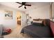 Bedroom featuring a ceiling fan, gaming themed decor, and ensuite bathroom at 18375 E San Ignacio Ct, Gold Canyon, AZ 85118