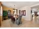 Elegant dining room features decorative chairs, a chandelier, and views into the kitchen and living area at 18375 E San Ignacio Ct, Gold Canyon, AZ 85118