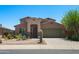 Two-story home features desert landscaping, a three-car garage, and a welcoming entrance at 18375 E San Ignacio Ct, Gold Canyon, AZ 85118