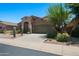 Well-maintained single-Gathering home featuring a desert landscaped front yard and a two-car garage at 18375 E San Ignacio Ct, Gold Canyon, AZ 85118
