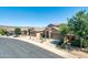 Charming single-Gathering home with a well-manicured front yard featuring desert landscaping and a spacious driveway at 18375 E San Ignacio Ct, Gold Canyon, AZ 85118