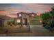 Inviting two-story home with desert landscaping, a three-car garage, and a well-maintained lawn at 18375 E San Ignacio Ct, Gold Canyon, AZ 85118