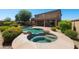 Luxurious backyard with a sparkling pool, hot tub, and lush landscaping for ultimate relaxation at 18375 E San Ignacio Ct, Gold Canyon, AZ 85118