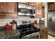 Close-up of the kitchen featuring stainless steel appliances, granite countertops, and wood cabinets at 18375 E San Ignacio Ct, Gold Canyon, AZ 85118