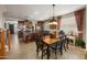 Open-concept kitchen and dining area with wood cabinets, granite countertops, and stainless steel appliances at 18375 E San Ignacio Ct, Gold Canyon, AZ 85118