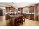 Spacious kitchen with a large island, granite countertops, stainless steel appliances, and wood cabinets at 18375 E San Ignacio Ct, Gold Canyon, AZ 85118
