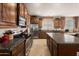 Well-lit kitchen featuring granite countertops, stainless steel appliances, and ample wood cabinetry for storage at 18375 E San Ignacio Ct, Gold Canyon, AZ 85118