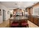 Open kitchen featuring a central island with granite countertops, wood cabinetry, and stainless steel appliances at 18375 E San Ignacio Ct, Gold Canyon, AZ 85118